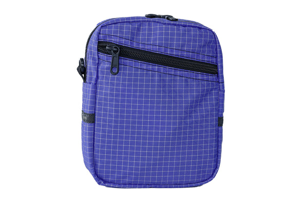 An Everyday Cubelet in Selkie Halcyon (purplish-blue with a white grid) with a front zipper.